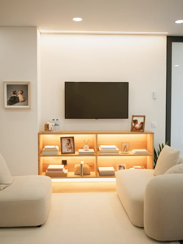Zona de descanso acolhedora no estúdio fotográfico maternidade com sofás neutros e decoração minimalista.